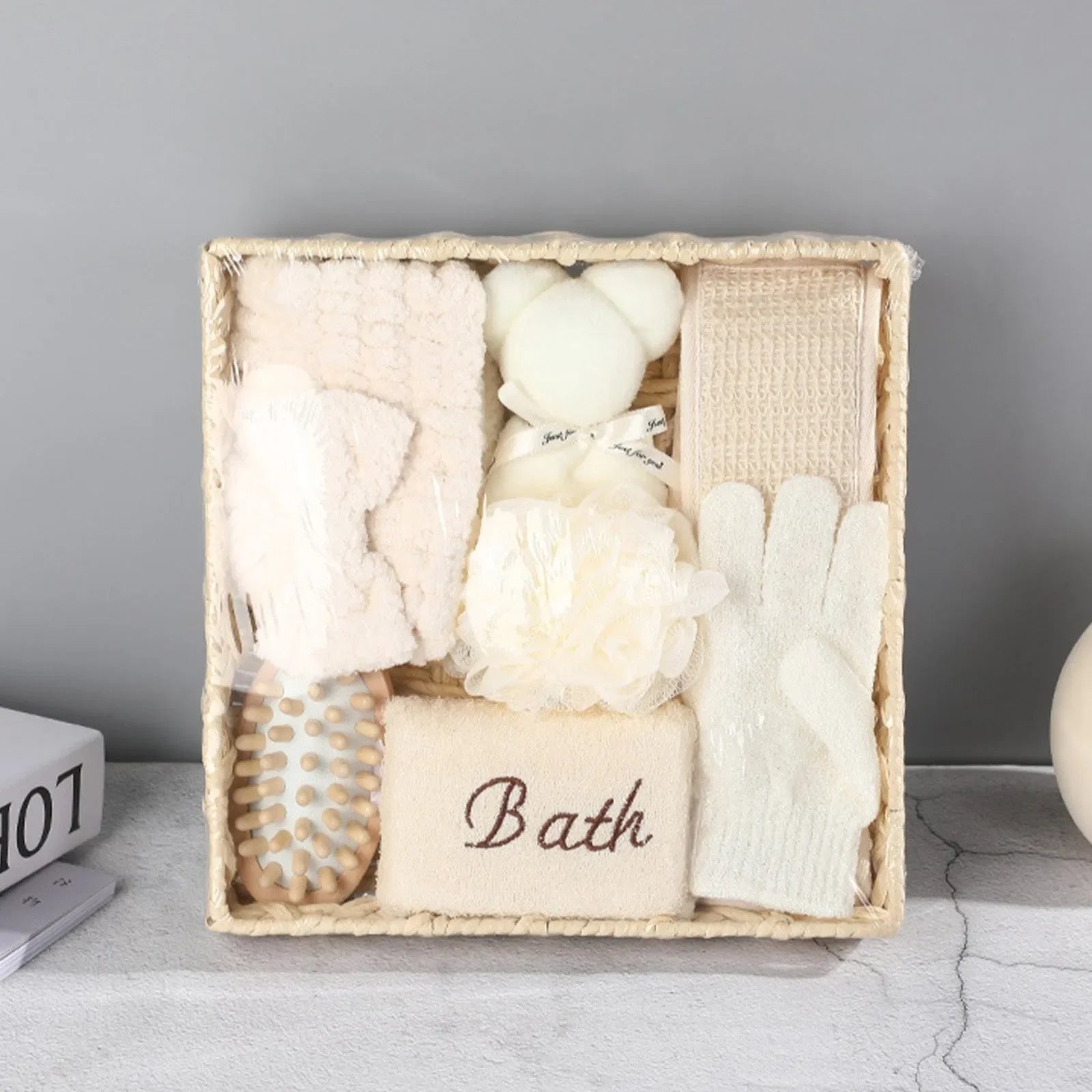 Spa bath gift set with brush, loofah, gloves, towel labeled 'Bath' in woven basket